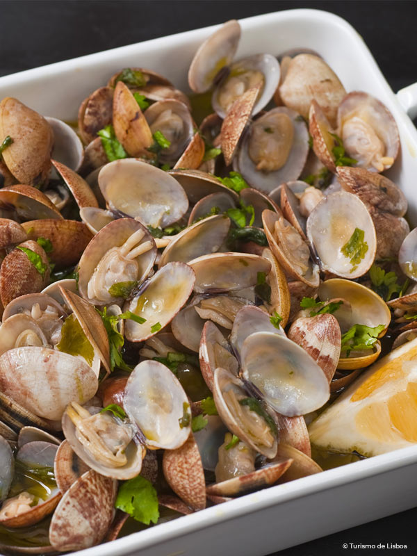 Plate of food with seafood, clams, herbs, olive oil and lemon