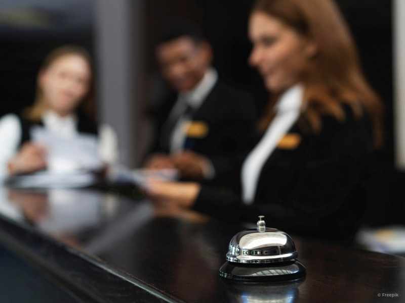 Blurred photo of hotel lobby with focus on the bell.