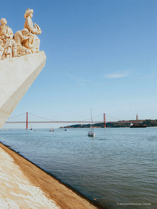 View of Belem in a sunny day, with the Tagus river the 25th April bridge and the Padrão dos Descobrimentos visible, in Portugal.